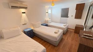 a hotel room with two beds and a window at Dar Chefchaouen in Chefchaouen