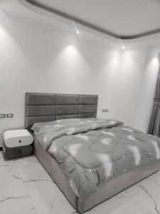 a bed in a white room with at Majestic Dream living in Addis Ababa