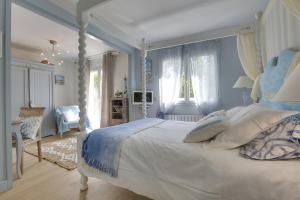 a bedroom with a white bed with a canopy at Cap Mango Paradise in Capbreton +32 photos