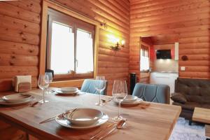 a wooden table with plates and wine glasses on it at Landhausidylle in Sankt Gilgen
