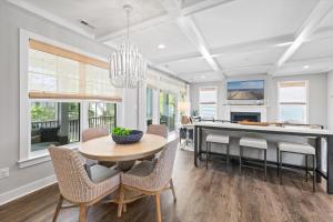 a dining room with a table and chairs and a kitchen at 5br Beauty Near Bethany-community Pool Linens in Ocean View
