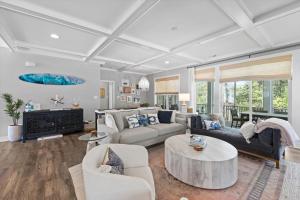 a living room with a couch and a table at 5br Beauty Near Bethany-community Pool Linens in Ocean View