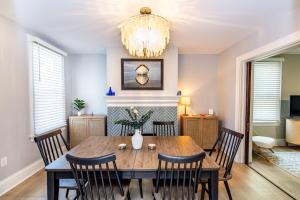 a dining room with a table and chairs and a chandelier at Newly Renovated In Dta W Parking in Annapolis