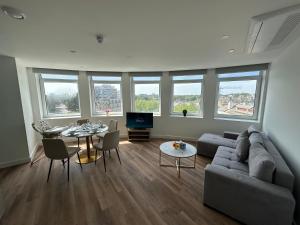a living room with a couch and a table at Bournemouth Lookout in Bournemouth