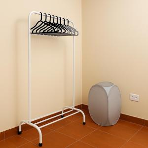 a metal bed in a corner of a room at Habitación frente a centro comercial in Víctor Larco Herrera