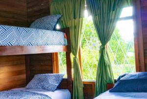 two bunk beds in a room with a window at Family villa in Puyo in Tarqui