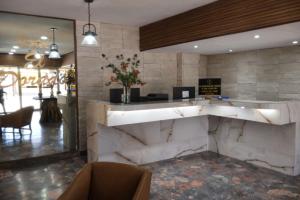 a lobby of a restaurant with a large marble counter at Hotel El Dorado in Sabinas