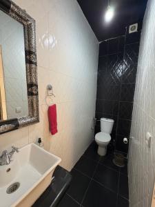 a bathroom with a sink and a toilet and a mirror at Sweet home in Marrakech