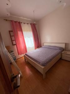 a bedroom with a bed and a window at Sweet home in Marrakech