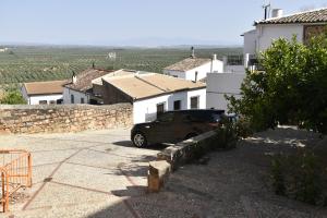 a black truck parked in front of a building at Casa rural El Carmen in Baños de la Encina