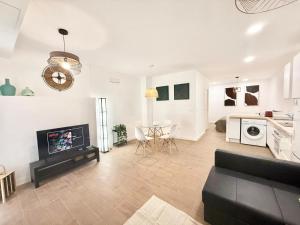 a living room with a fireplace and a table in it at Renfe Asamblea de Madrid 03 AMCH Hospedaje in Madrid