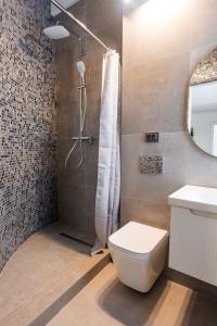 a bathroom with a shower and a toilet and a sink at Yaremche Apartments in Yaremche