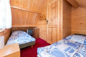 Postel nebo postele na pokoji v ubytování Domki Letniskowe Neptun