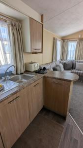 una cucina con un lavello e un piano di lavoro di Happy Feet Pet Friendly Holiday Home Skipsea Sands, Bridlington a Bridlington