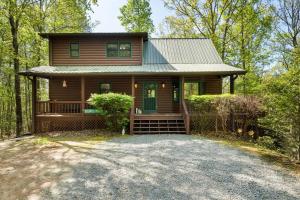 a house in the woods with a driveway at Boujee Bear Lodge - A Peaceful Cabin in the Woods in Morganton