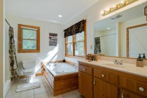 a bathroom with a tub and a toilet and a sink at Boujee Bear Lodge - A Peaceful Cabin in the Woods in Morganton +37 photos