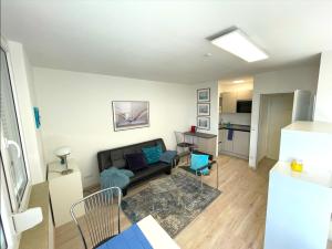 a living room with a couch and a table at Appartment Schwabenblick in Augsburg