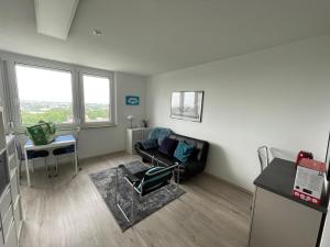 a living room with a couch and a chair at Appartment Schwabenblick in Augsburg