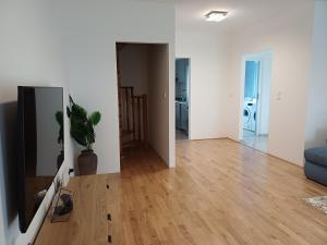 a living room with a blue couch and a wooden floor at Holiday Home Pampas in Slavonski Brod