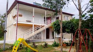 a house with a staircase in front of it at Green Palms-მწვანე პალმები in Martvili