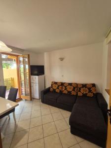 a living room with a couch and a kitchen at Marjetica 40 in Moravske-Toplice