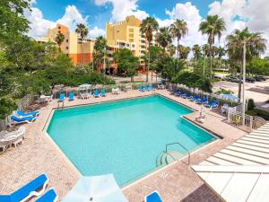 a swimming pool with lounge chairs and a resort at Vacation Village at Bonaventure, Fort Lauderdale in Weston