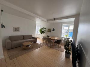 a living room with a couch and a table at Andra in Aalborg