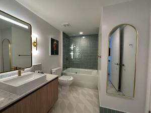 a bathroom with a sink and a toilet and a shower at Downtown Miami view - 38th floor gem in Miami