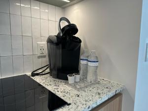 a counter with two bottles of water on it at Downtown Miami view - 38th floor gem in Miami