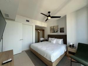a bedroom with a bed and a ceiling fan at Downtown Miami view - 38th floor gem in Miami