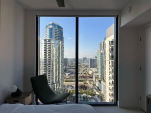 a bedroom with a view of a city from a window at Downtown Miami view - 38th floor gem in Miami