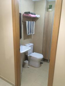 a bathroom with a toilet and a sink at Piso Salón Paraíso in Bueu