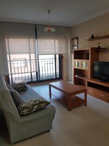 a living room with a couch and a coffee table at Piso Salón Paraíso in Bueu