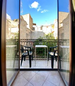 a view of a balcony with two chairs and a table at La Ginestra in Corleone