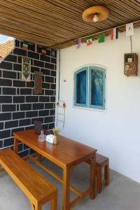 a table and bench in front of a wall at Casa De' Summer Banyuwangi in Banyuwangi +29 photos