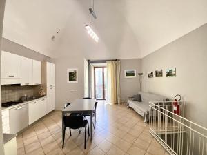 a kitchen and a living room with a table at La Ginestra in Corleone