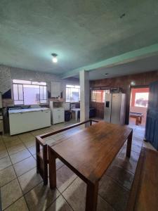 a large kitchen with a wooden table in a room at República Boemia in Ouro Preto