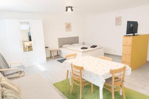 a living room with a table and a kitchen at Ubytování na faře in Prague +1 photo