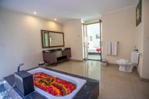 a bathroom with a bath tub filled with flowers at 1BR Private Pool Villa in Seminyak PB in Seminyak