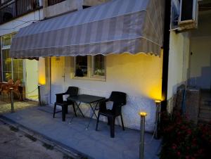 a table and chairs sitting outside of a building at Apartment Sekulovski in Ohrid