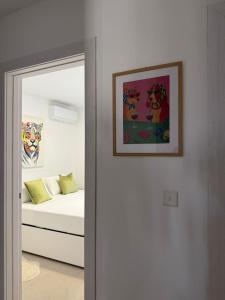 a bedroom with a bed and a picture on the wall at Gemini Court Apartment in Marsaxlokk