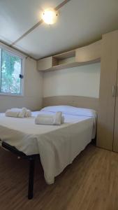 a large white bed in a room with a window at Europe Garden Silvi in Silvi Marina
