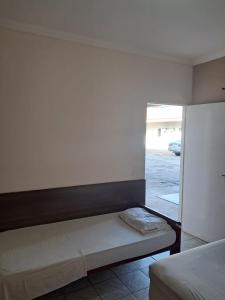 een bed in een kamer met een raam bij Hotel Castro Alves in Marília