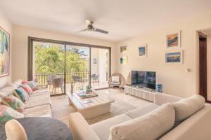 a living room with a couch and a tv at Apartment with 2bedrooms in Portillo Residences in Abra Grande