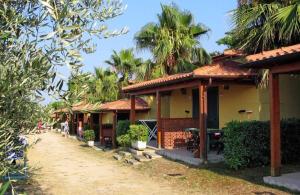 a row of houses with palm trees in the background at Europe Garden Silvi in Silvi Marina