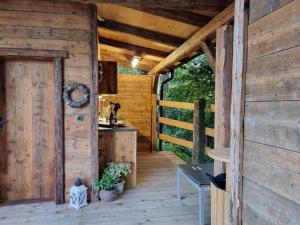 an outside view of a wooden cabin with a door at western cottage in Rečica ob Savinji