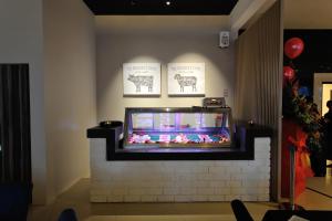 a television on a brick wall with a tv on it at Abell Hotel in Kuching