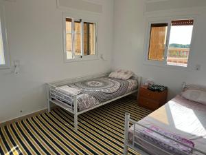 a bedroom with a bed and two windows at Penthouse Armonía in Briech