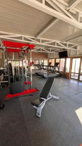 a gym with a treadmill and a bench in a room at Hotel Vento in Copiapó