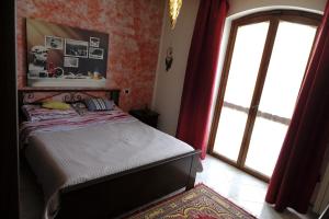 a bedroom with a bed and a sliding glass door at Villa con giardino in Pontecurone